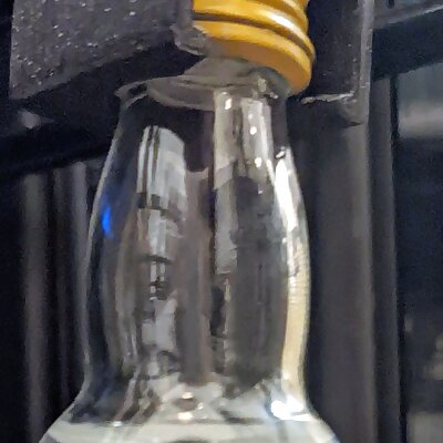 Clip to hang small bottle in mini fridge