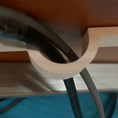 Cable holder under the table