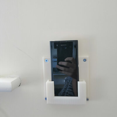 Wall mounted phone holder
