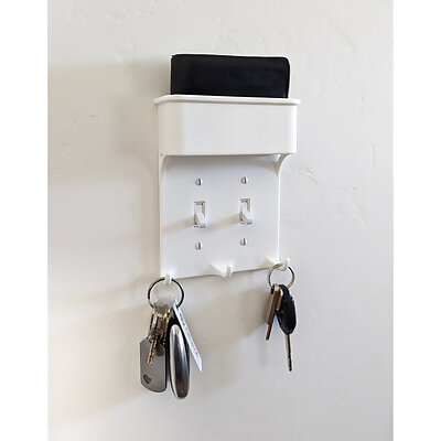 Light switch plate with key hooks and wallet pocket