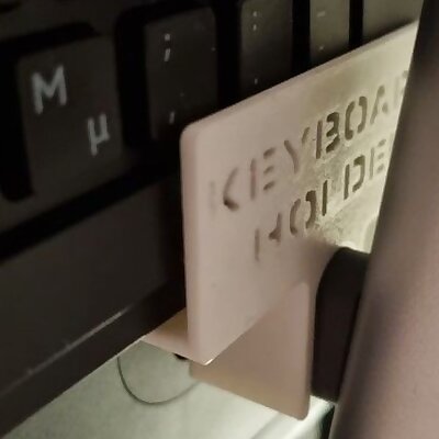 Keyboard holder on top of a monitor