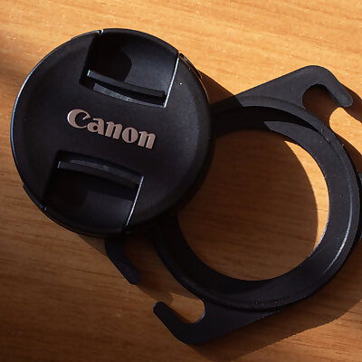 Lens cap holder for camera strap