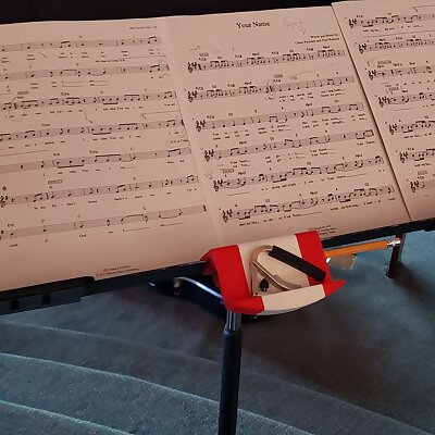 Guitarist capo and pencil holder on a music stand